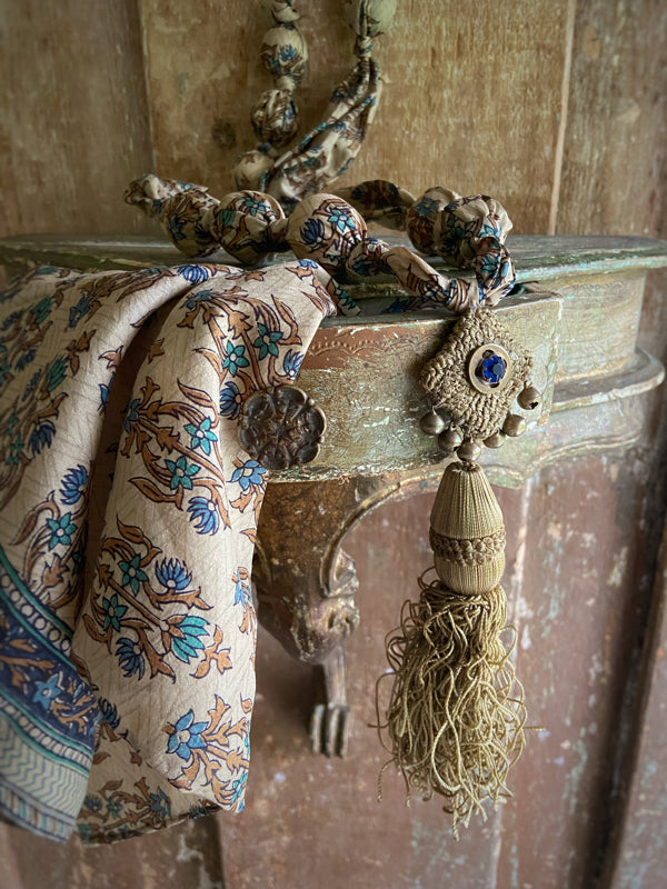 1920s style long silk sautoir necklace with antique tassel embellishment. Bohemian style from vintage textiles by Pavilion Parade. 