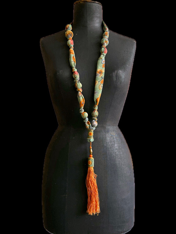 1920s style long silk sautoir necklace with antique tassel embellishment. Bohemian style from vintage textiles by Pavilion Parade. 