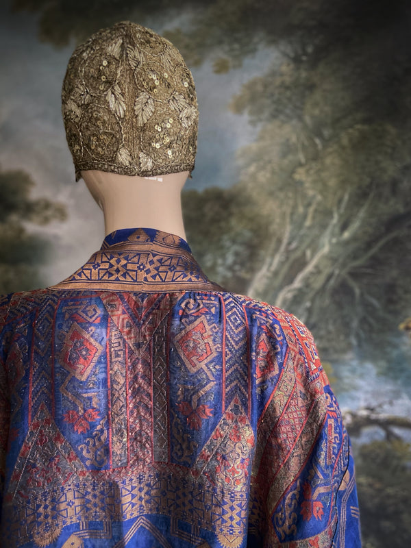 Egyptian Revival 1920s inspired full length robe created from vintage and antique textiles. Lapiz lazuli blue and metallic bronze-gold silk brocade. Lined in block printed silk with design of ancient Egyptian figures, pyramids, chariots. Bohemian style from Pavilion Parade.