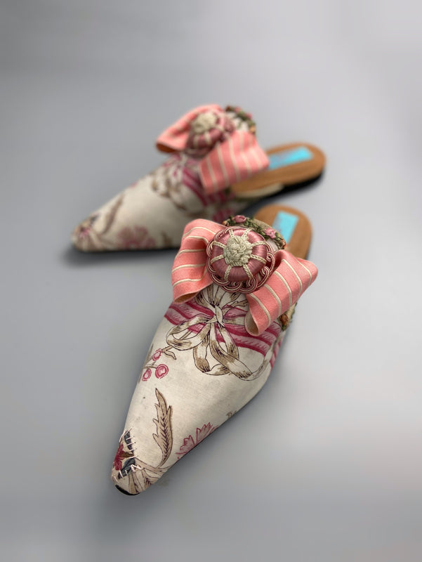 Marie Antoinette inspired shoes created from antique early 1800s rose pink and ivory block printed French cotton toile and embellished with pink silk passementerie rosettes. Bohemian style from the Pavilion Parade studio.