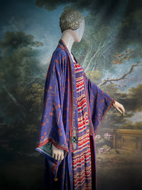 Egyptian Revival 1920s inspired full length robe created from vintage and antique textiles. Lapiz lazuli blue and scarlet silk crepe. Lined in block printed silk with design of ancient Egyptian figures, pyramids, chariots. Bohemian style from Pavilion Parade.