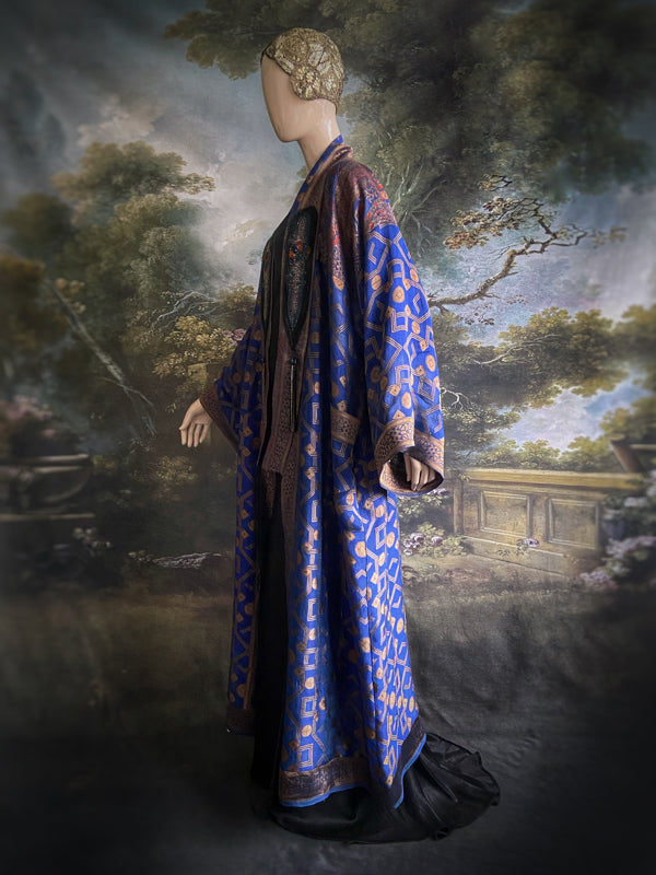 Egyptian Revival 1920s inspired full length robe created from vintage and antique textiles. Lapiz lazuli blue and metallic bronze-gold silk brocade. Lined in block printed silk with design of ancient Egyptian figures, pyramids, chariots. Bohemian style from Pavilion Parade.