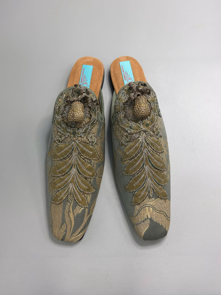 French grey silk brocade and 19th century metallic silver lace are used to create bohemian style shoes with hand worked antique acorn embellishment. Unique style by the Pavilion Parade studio.