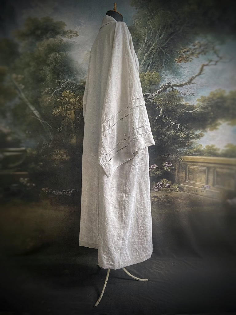 Full length kimono inspired robe with large patch pockets and wide sleeves. Created from an antique heavy French linen trousseau sheet with heirloom embroidery and drawn thread work. All French seamed with hand finished hems and collar. Bohemian styles sustainably created from antique and vintage textiles by the Pavilion Parade studio.