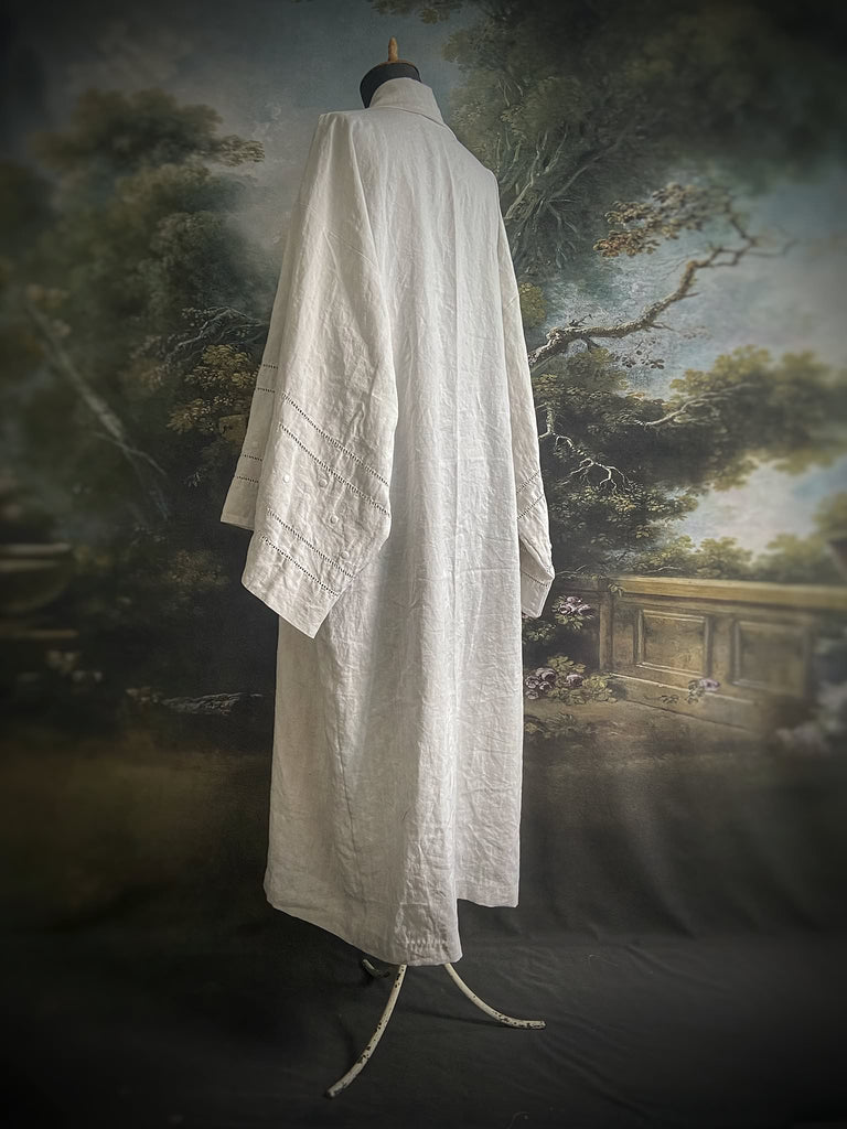 Full length kimono inspired robe with large patch pockets and wide sleeves. Created from an antique heavy French linen trousseau sheet with heirloom embroidery and drawn thread work. All French seamed with hand finished hems and collar. Bohemian styles sustainably created from antique and vintage textiles by the Pavilion Parade studio.