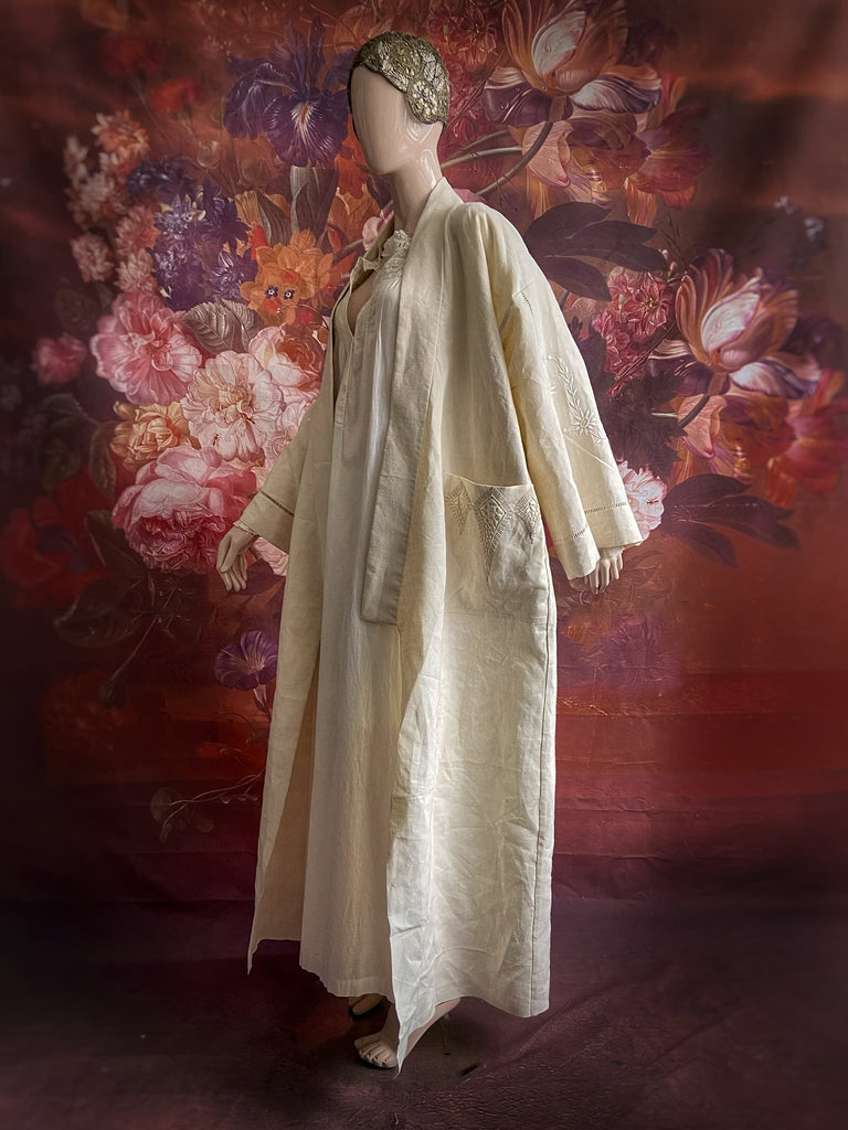 Full length kimono inspired robe with large patch pockets and wide sleeves. Created from an antique heavy French linen trousseau sheet with heirloom embroidery and drawn thread work. All French seamed with hand finished hems and collar. Bohemian styles sustainably created from antique and vintage textiles by the Pavilion Parade studio.