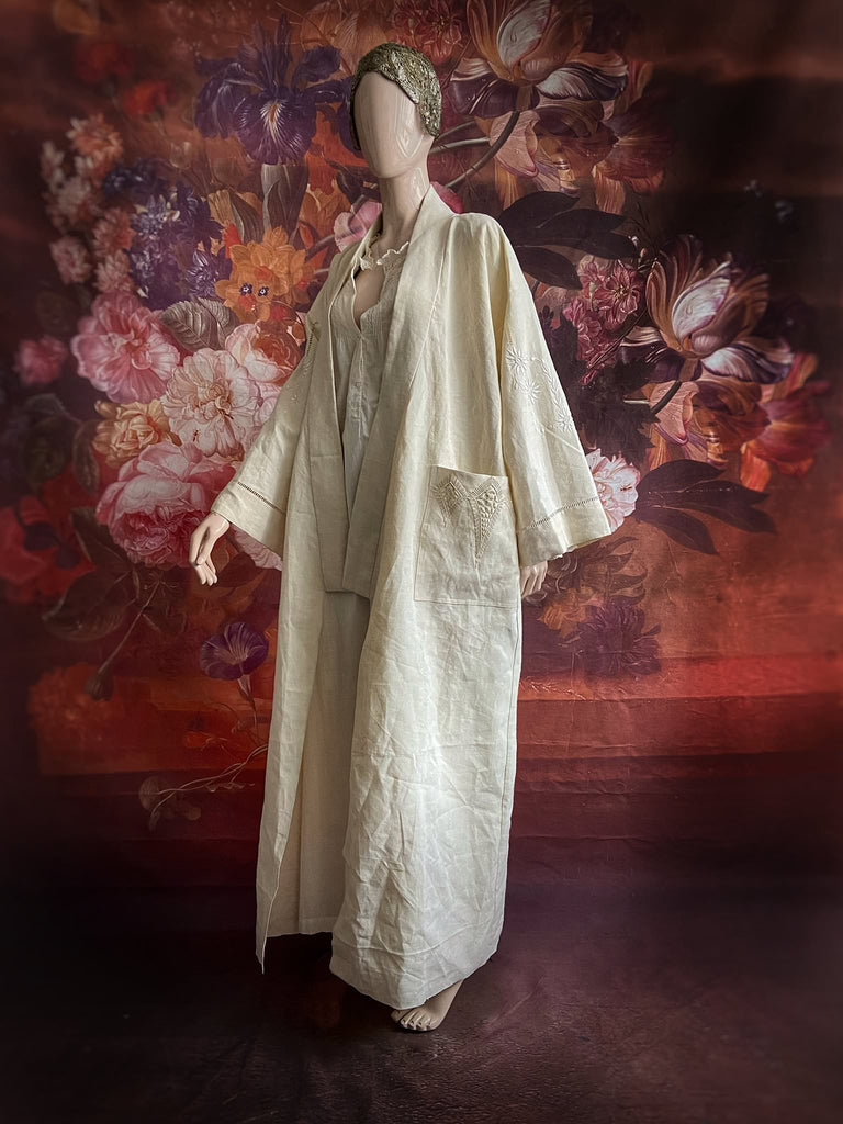 Full length kimono inspired robe with large patch pockets and wide sleeves. Created from an antique heavy French linen trousseau sheet with heirloom embroidery and drawn thread work. All French seamed with hand finished hems and collar. Bohemian styles sustainably created from antique and vintage textiles by the Pavilion Parade studio.