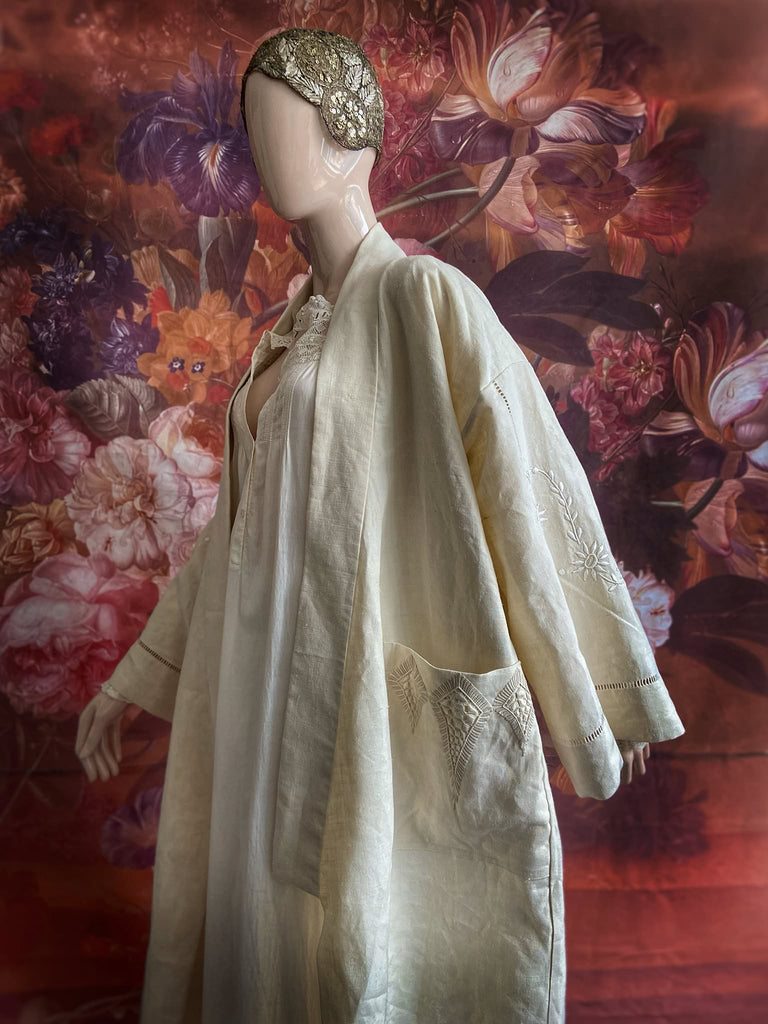 Full length kimono inspired robe with large patch pockets and wide sleeves. Created from an antique heavy French linen trousseau sheet with heirloom embroidery and drawn thread work. All French seamed with hand finished hems and collar. Bohemian styles sustainably created from antique and vintage textiles by the Pavilion Parade studio.
