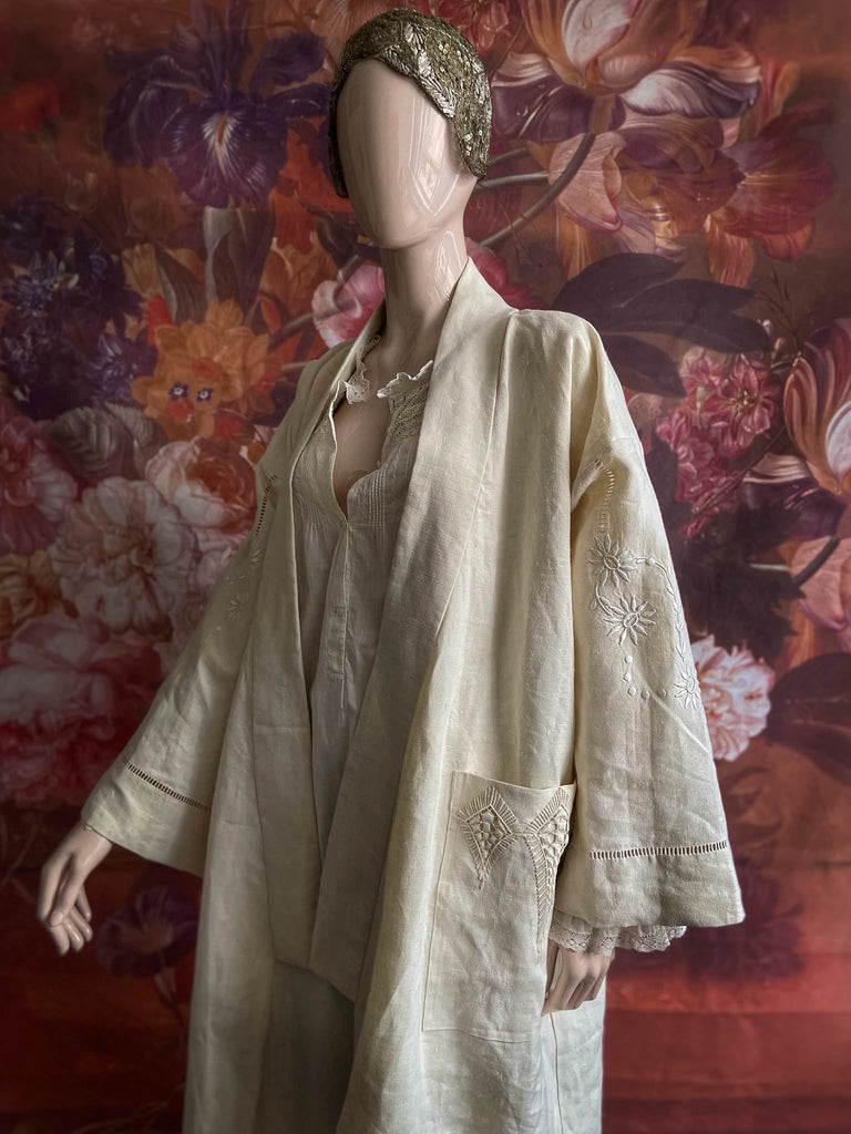 Full length kimono inspired robe with large patch pockets and wide sleeves. Created from an antique heavy French linen trousseau sheet with heirloom embroidery and drawn thread work. All French seamed with hand finished hems and collar. Bohemian styles sustainably created from antique and vintage textiles by the Pavilion Parade studio.