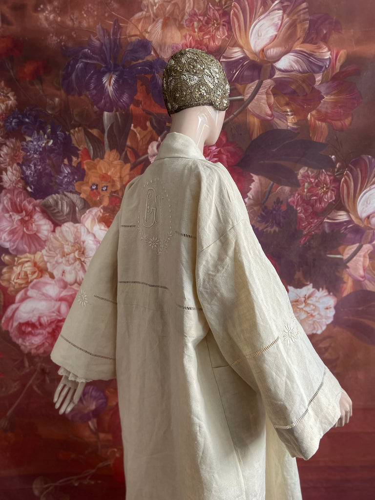 Full length kimono inspired robe with large patch pockets and wide sleeves. Created from an antique heavy French linen trousseau sheet with heirloom embroidery and drawn thread work. All French seamed with hand finished hems and collar. Bohemian styles sustainably created from antique and vintage textiles by the Pavilion Parade studio.
