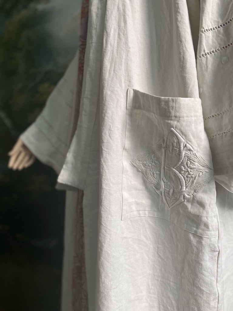 Full length kimono inspired robe with large patch pockets and wide sleeves. Created from an antique heavy French linen trousseau sheet with heirloom embroidery and drawn thread work. All French seamed with hand finished hems and collar. Bohemian styles sustainably created from antique and vintage textiles by the Pavilion Parade studio.