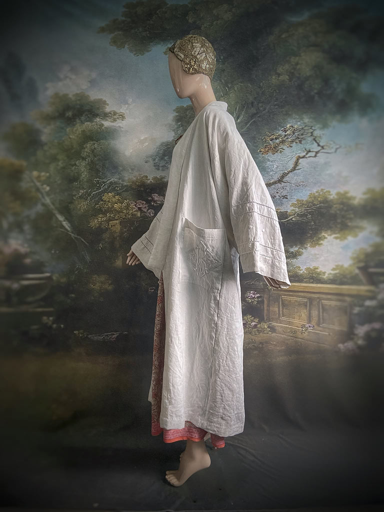 Full length kimono inspired robe with large patch pockets and wide sleeves. Created from an antique heavy French linen trousseau sheet with heirloom embroidery and drawn thread work. All French seamed with hand finished hems and collar. Bohemian styles sustainably created from antique and vintage textiles by the Pavilion Parade studio.