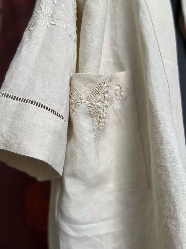 Full length kimono inspired robe with large patch pockets and wide sleeves. Created from an antique heavy French linen trousseau sheet with heirloom embroidery and drawn thread work. All French seamed with hand finished hems and collar. Bohemian styles sustainably created from antique and vintage textiles by the Pavilion Parade studio.