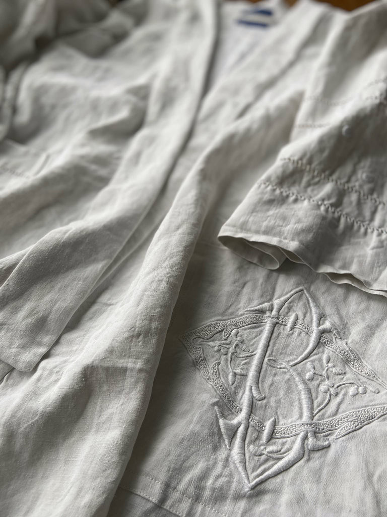 Full length kimono inspired robe with large patch pockets and wide sleeves. Created from an antique heavy French linen trousseau sheet with heirloom embroidery and drawn thread work. All French seamed with hand finished hems and collar. Bohemian styles sustainably created from antique and vintage textiles by the Pavilion Parade studio.