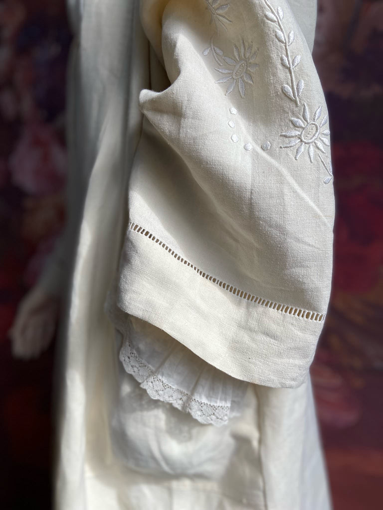 Full length kimono inspired robe with large patch pockets and wide sleeves. Created from an antique heavy French linen trousseau sheet with heirloom embroidery and drawn thread work. All French seamed with hand finished hems and collar. Bohemian styles sustainably created from antique and vintage textiles by the Pavilion Parade studio.