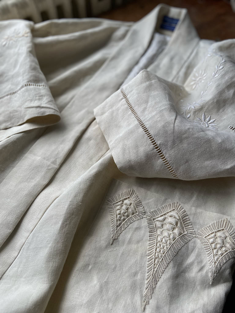 Full length kimono inspired robe with large patch pockets and wide sleeves. Created from an antique heavy French linen trousseau sheet with heirloom embroidery and drawn thread work. All French seamed with hand finished hems and collar. Bohemian styles sustainably created from antique and vintage textiles by the Pavilion Parade studio.