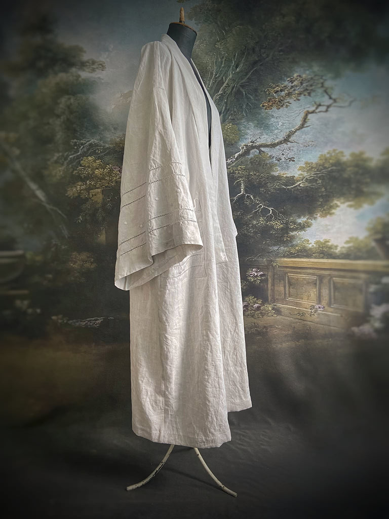 Full length kimono inspired robe with large patch pockets and wide sleeves. Created from an antique heavy French linen trousseau sheet with heirloom embroidery and drawn thread work. All French seamed with hand finished hems and collar. Bohemian styles sustainably created from antique and vintage textiles by the Pavilion Parade studio.
