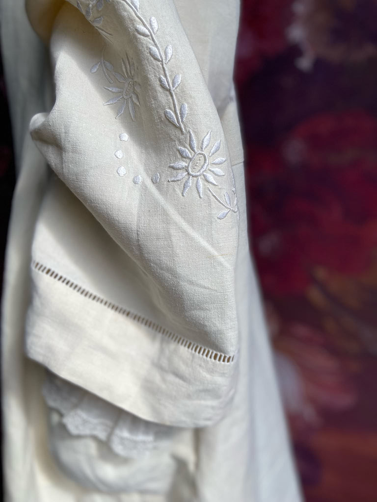 Full length kimono inspired robe with large patch pockets and wide sleeves. Created from an antique heavy French linen trousseau sheet with heirloom embroidery and drawn thread work. All French seamed with hand finished hems and collar. Bohemian styles sustainably created from antique and vintage textiles by the Pavilion Parade studio.