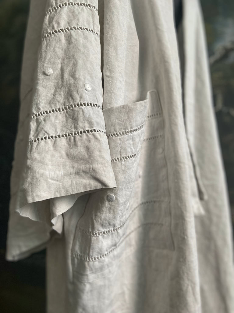 Full length kimono inspired robe with large patch pockets and wide sleeves. Created from an antique heavy French linen trousseau sheet with heirloom embroidery and drawn thread work. All French seamed with hand finished hems and collar. Bohemian styles sustainably created from antique and vintage textiles by the Pavilion Parade studio.