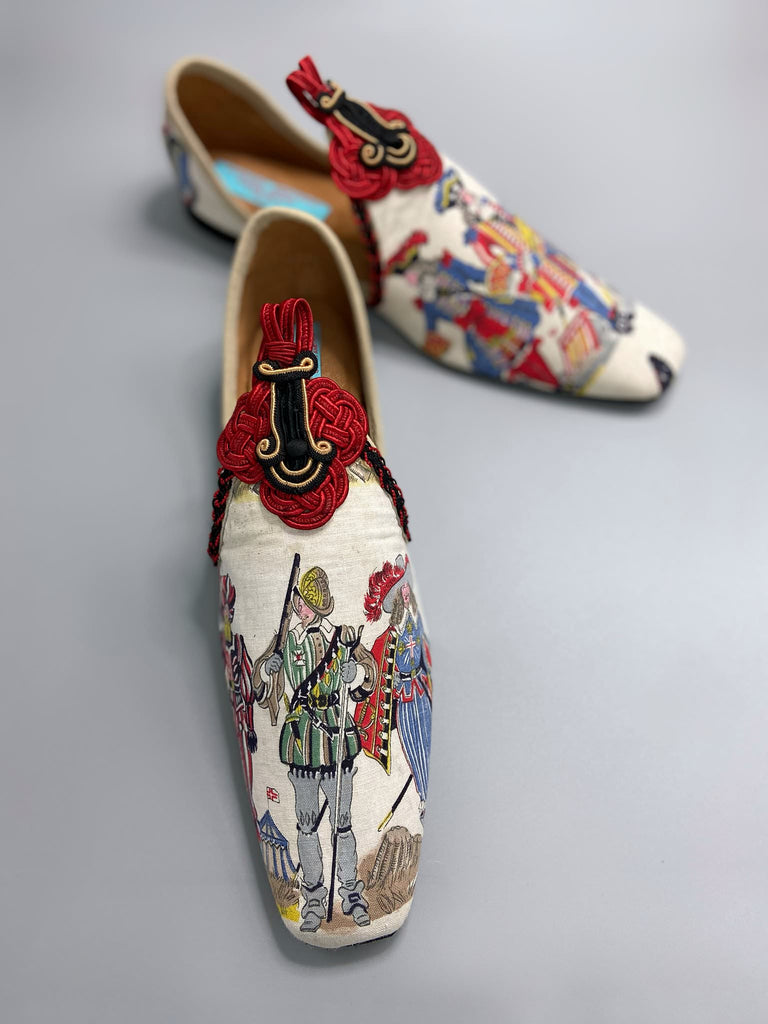 Historic military uniformed soldiers from a vintage French printed toile, and scarlet soutache frogging are used to create unique bohemian shoes by Pavilion Parade