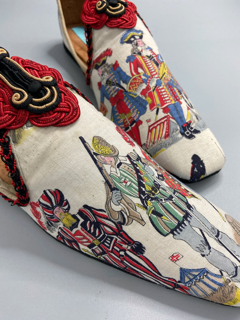 Historic military uniformed soldiers from a vintage French printed toile, and scarlet soutache frogging are used to create unique bohemian shoes by Pavilion Parade