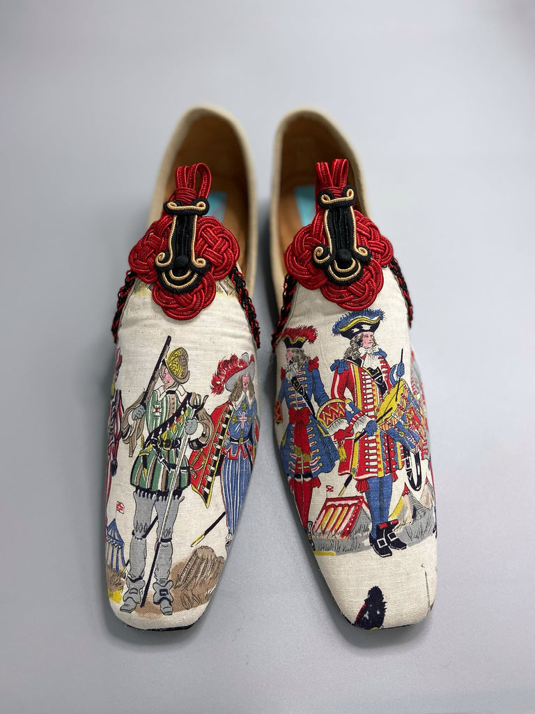Historic military uniformed soldiers from a vintage French printed toile, and scarlet soutache frogging are used to create unique bohemian shoes by Pavilion Parade