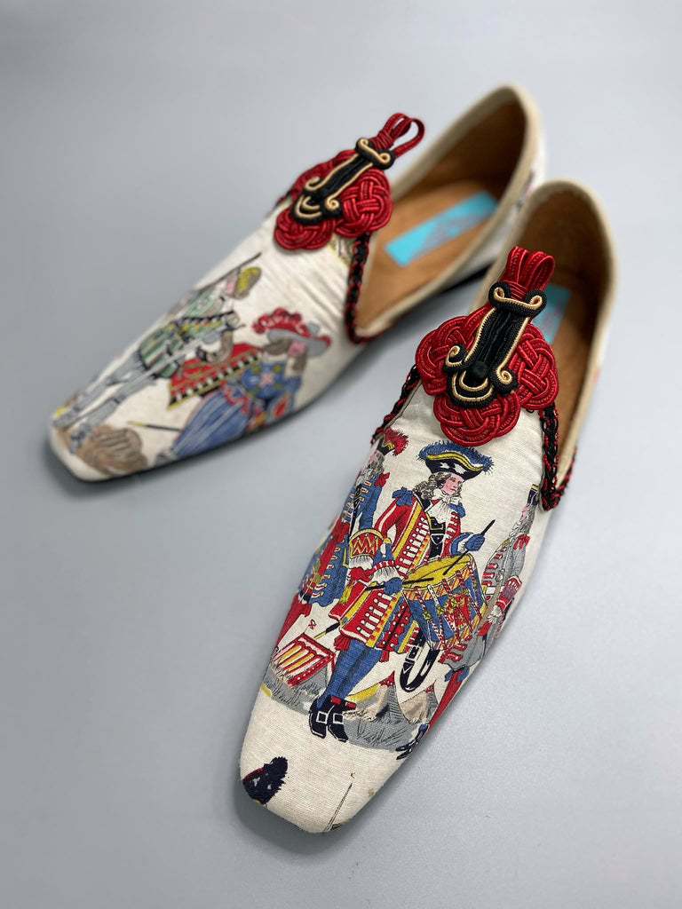 Historic military uniformed soldiers from a vintage French printed toile, and scarlet soutache frogging are used to create unique bohemian shoes by Pavilion Parade