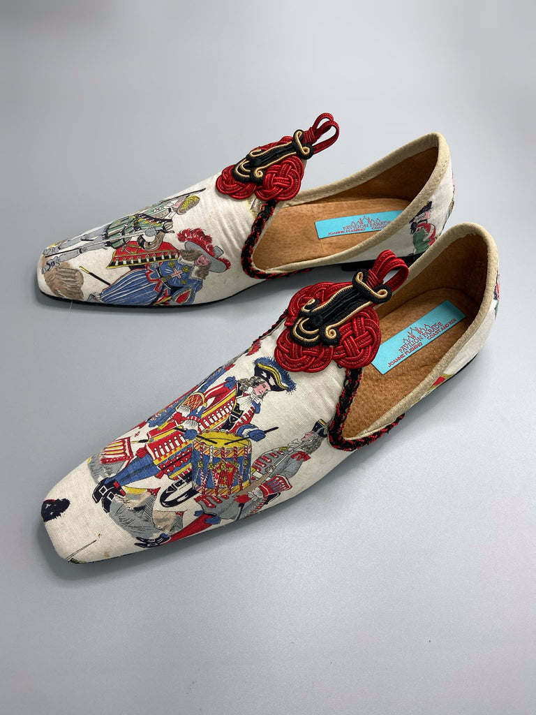 Historic military uniformed soldiers from a vintage French printed toile, and scarlet soutache frogging are used to create unique bohemian shoes by Pavilion Parade