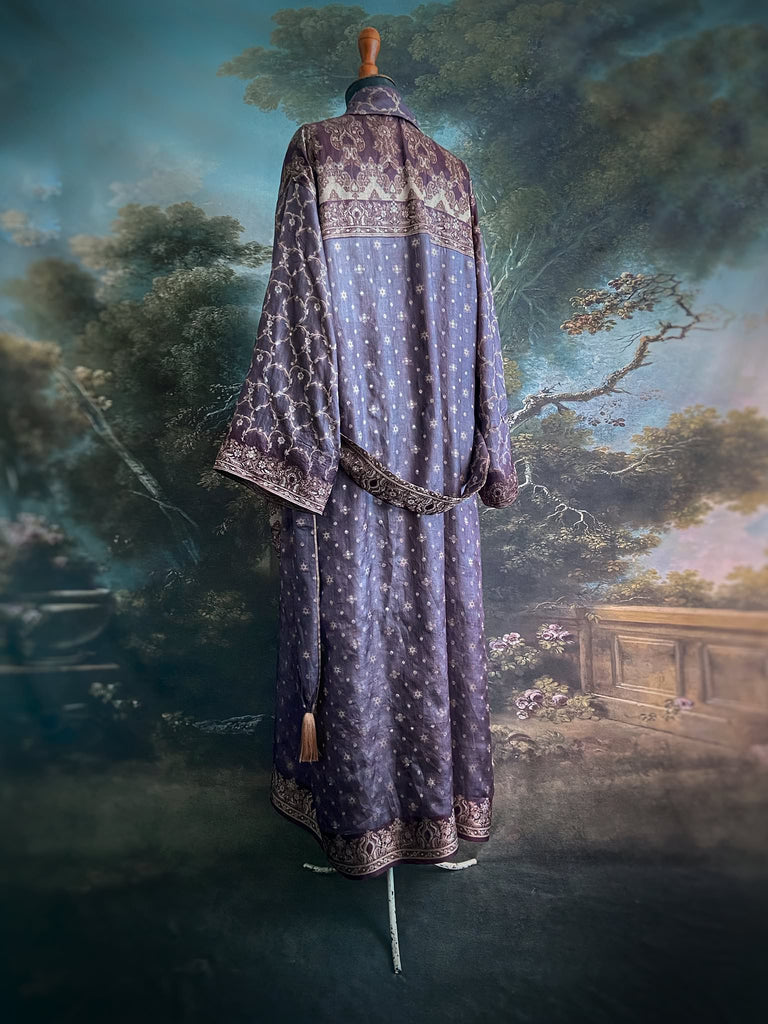 Dark lavender, aubergine, and silver-gilt silk robe with wide sleeves, tassel sash, and deep pockets. Unique bohemian styles sustainably created from vintage textiles by the Pavilion Parade studio.