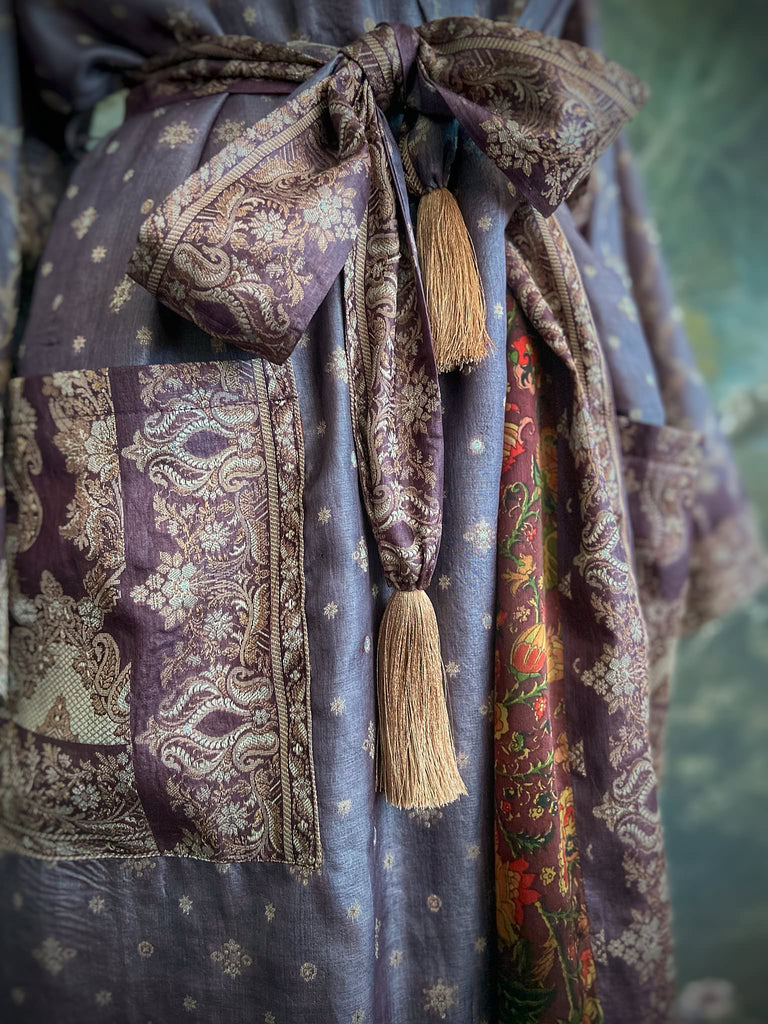 Dark lavender, aubergine, and silver-gilt silk robe with wide sleeves, tassel sash, and deep pockets. Unique bohemian styles sustainably created from vintage textiles by the Pavilion Parade studio.