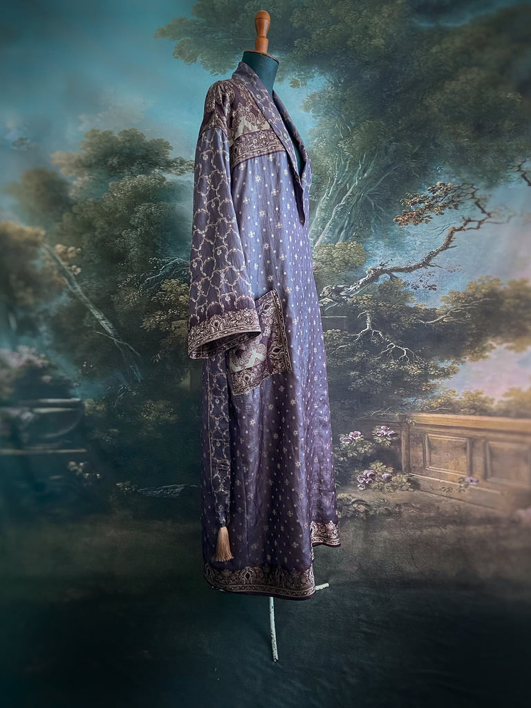 Dark lavender, aubergine, and silver-gilt silk robe with wide sleeves, tassel sash, and deep pockets. Unique bohemian styles sustainably created from vintage textiles by the Pavilion Parade studio.
