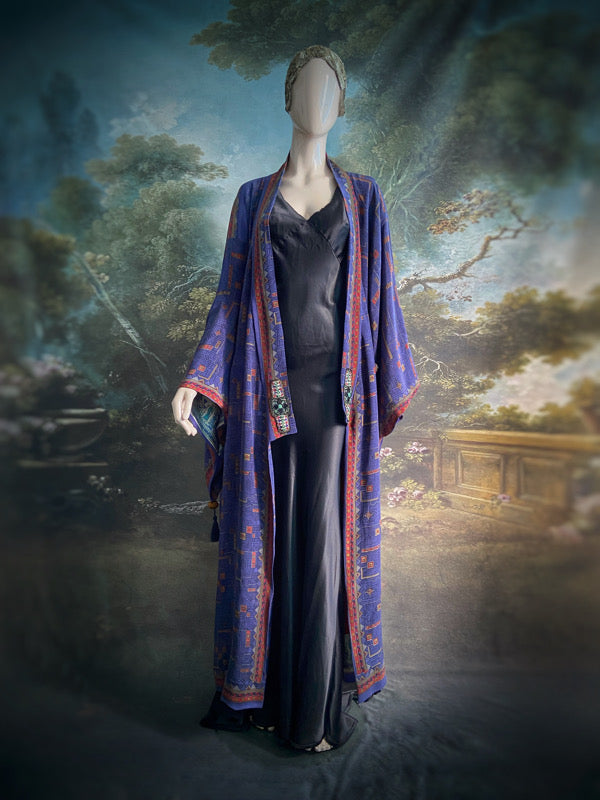 Egyptian Revival 1920s inspired full length robe created from vintage and antique textiles. Lapiz lazuli blue and scarlet silk crepe. Lined in block printed silk with design of ancient Egyptian figures, pyramids, chariots. Bohemian style from Pavilion Parade.