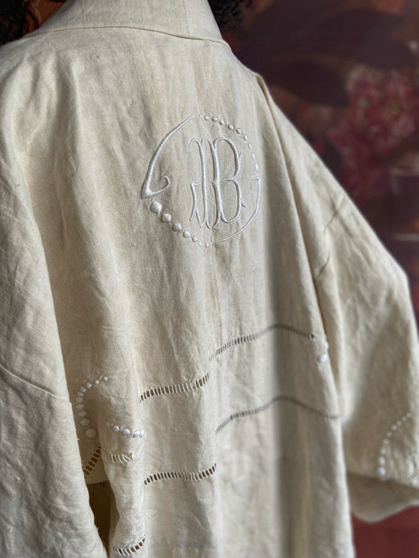 Full length kimono inspired robe with large patch pockets and wide sleeves. Created from an antique heavy French linen trousseau sheet with heirloom embroidery and drawn thread work. All French seamed with hand finished hems and collar. Bohemian styles sustainably created from antique and vintage textiles by the Pavilion Parade studio.