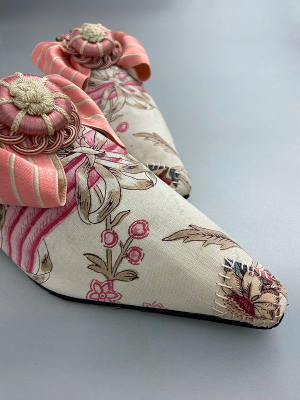 Marie Antoinette inspired shoes created from antique early 1800s rose pink and ivory block printed French cotton toile and embellished with pink silk passementerie rosettes. Bohemian style from the Pavilion Parade studio.