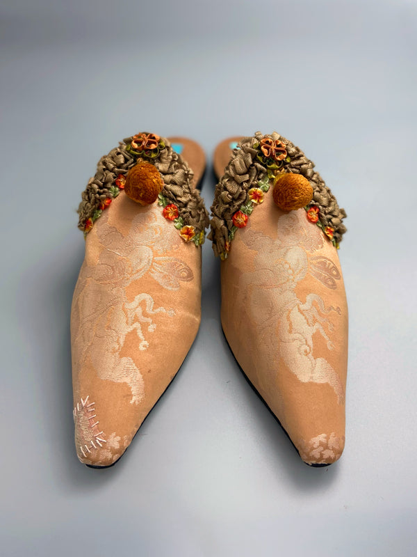 Apricot silk damask cherub shoes with pompom tassels, sustainably created from antique textiles by the Pavilion Parade studio