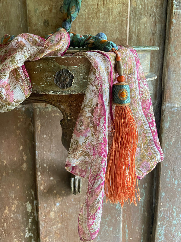1920s style long silk sautoir necklace with antique tassel embellishment. Bohemian style from vintage textiles by Pavilion Parade. 