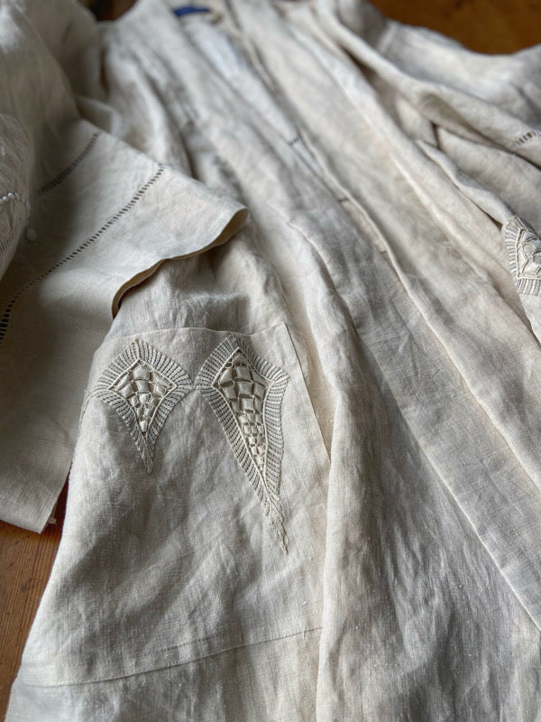 Full length kimono inspired robe with large patch pockets and wide sleeves. Created from an antique heavy French linen trousseau sheet with heirloom embroidery and drawn thread work. All French seamed with hand finished hems and collar. Bohemian styles sustainably created from antique and vintage textiles by the Pavilion Parade studio.