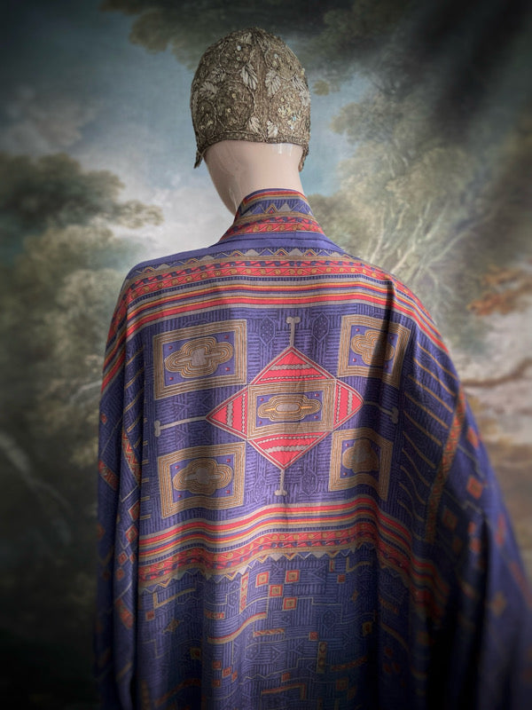 Egyptian Revival 1920s inspired full length robe created from vintage and antique textiles. Lapiz lazuli blue and scarlet silk crepe. Lined in block printed silk with design of ancient Egyptian figures, pyramids, chariots. Bohemian style from Pavilion Parade.