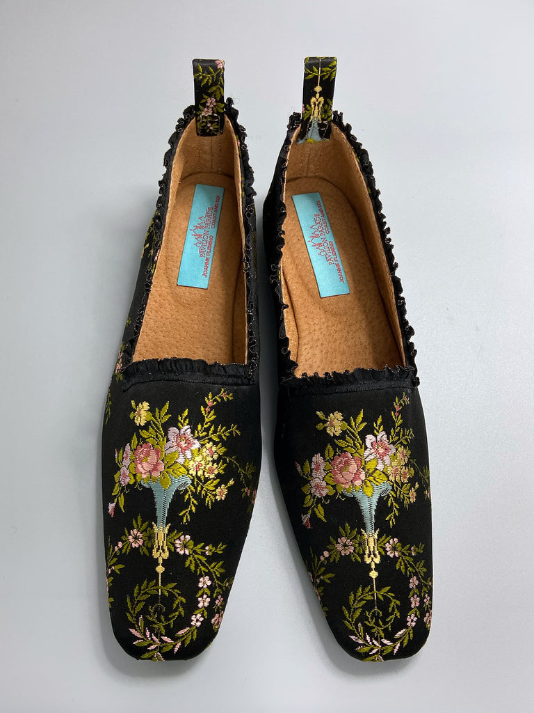 Black silk regency slipper shoes with floral embroidered posy motif. Squared toes and black silk satin ankle ribbons. Bohemian style created from antique textiles by the Pavilion Parade studio.