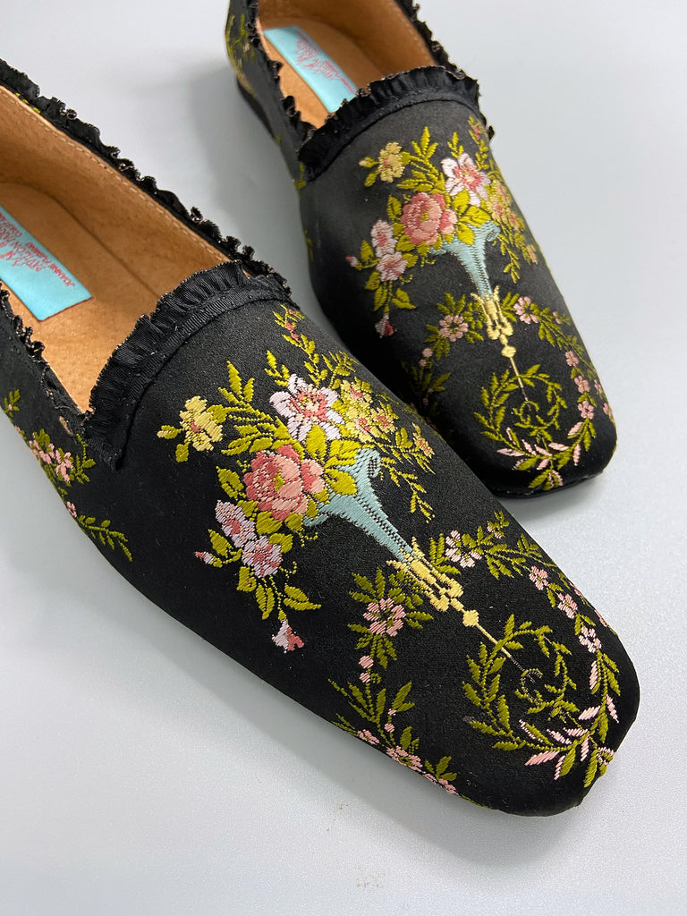 Black silk regency slipper shoes with floral embroidered posy motif. Squared toes and black silk satin ankle ribbons. Bohemian style created from antique textiles by the Pavilion Parade studio.