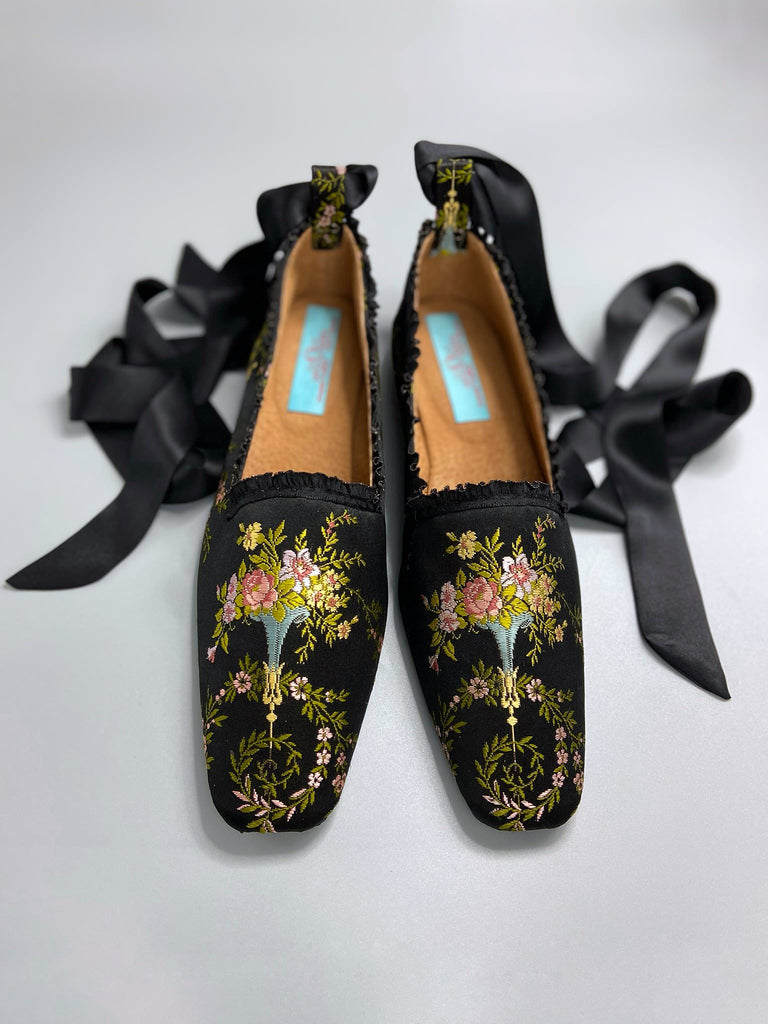 Black silk regency slipper shoes with floral embroidered posy motif. Squared toes and black silk satin ankle ribbons. Bohemian style created from antique textiles by the Pavilion Parade studio.