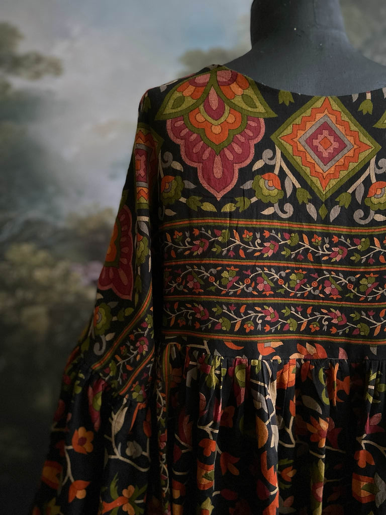 Vibrant Indian floral on black fine cotton muslin bohemian dress with full sleeves and pockets. Created from antique and vintage textiles by the Pavilion Parade studio