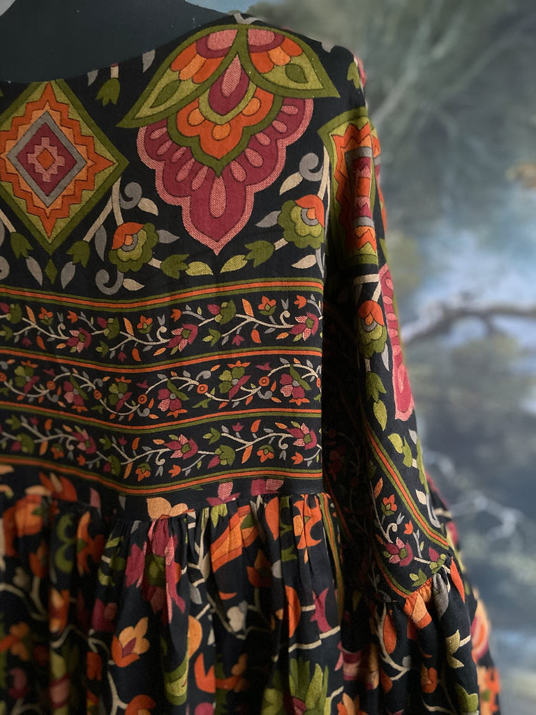 Vibrant Indian floral on black fine cotton muslin bohemian dress with full sleeves and pockets. Created from antique and vintage textiles by the Pavilion Parade studio