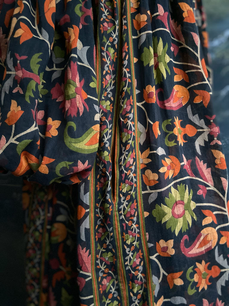 Vibrant Indian floral on black fine cotton muslin bohemian dress with full sleeves and pockets. Created from antique and vintage textiles by the Pavilion Parade studio