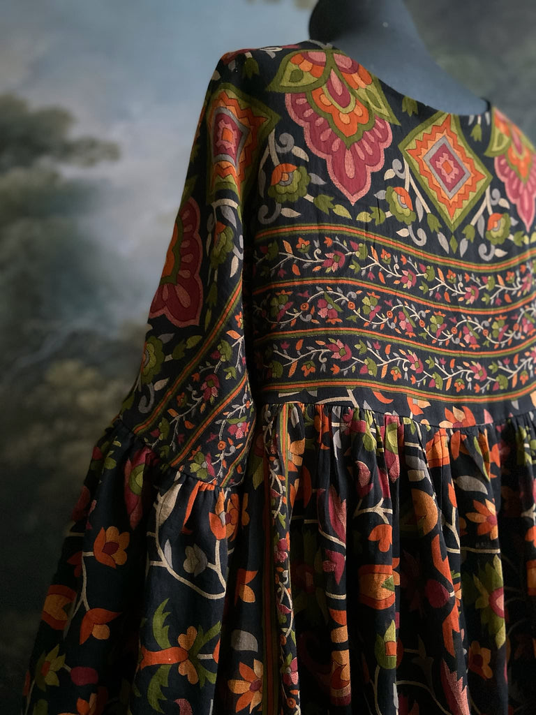 Vibrant Indian floral on black fine cotton muslin bohemian dress with full sleeves and pockets. Created from antique and vintage textiles by the Pavilion Parade studio