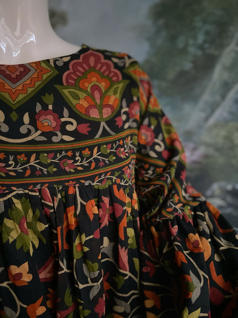 Vibrant Indian floral on black fine cotton muslin bohemian dress with full sleeves and pockets. Created from antique and vintage textiles by the Pavilion Parade studio