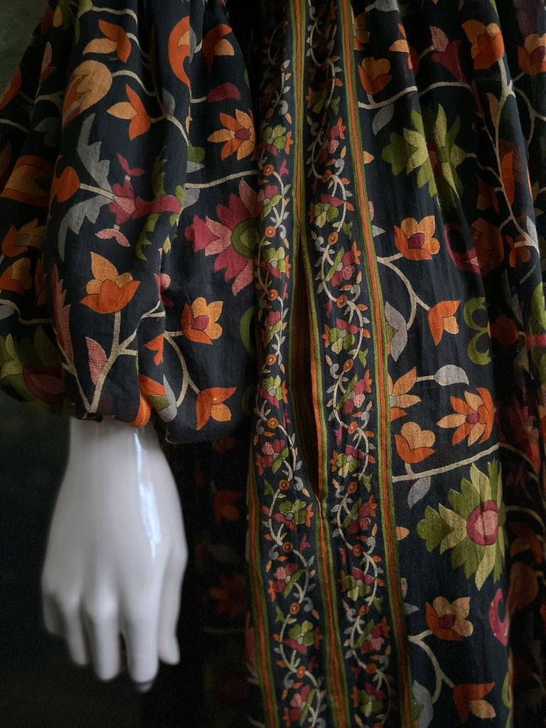 Vibrant Indian floral on black fine cotton muslin bohemian dress with full sleeves and pockets. Created from antique and vintage textiles by the Pavilion Parade studio
