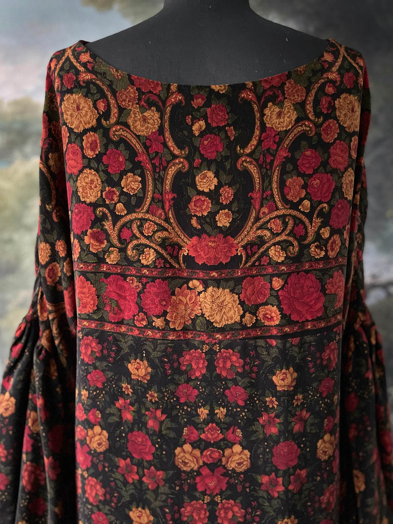 Black, crimson and saffron flower silk crepe dress with full sleeves gathered in to wrist.  Side pockets and shallow scoop neckline. Bohemian style created from vintage and antique textiles by the Pavilion Parade studio.