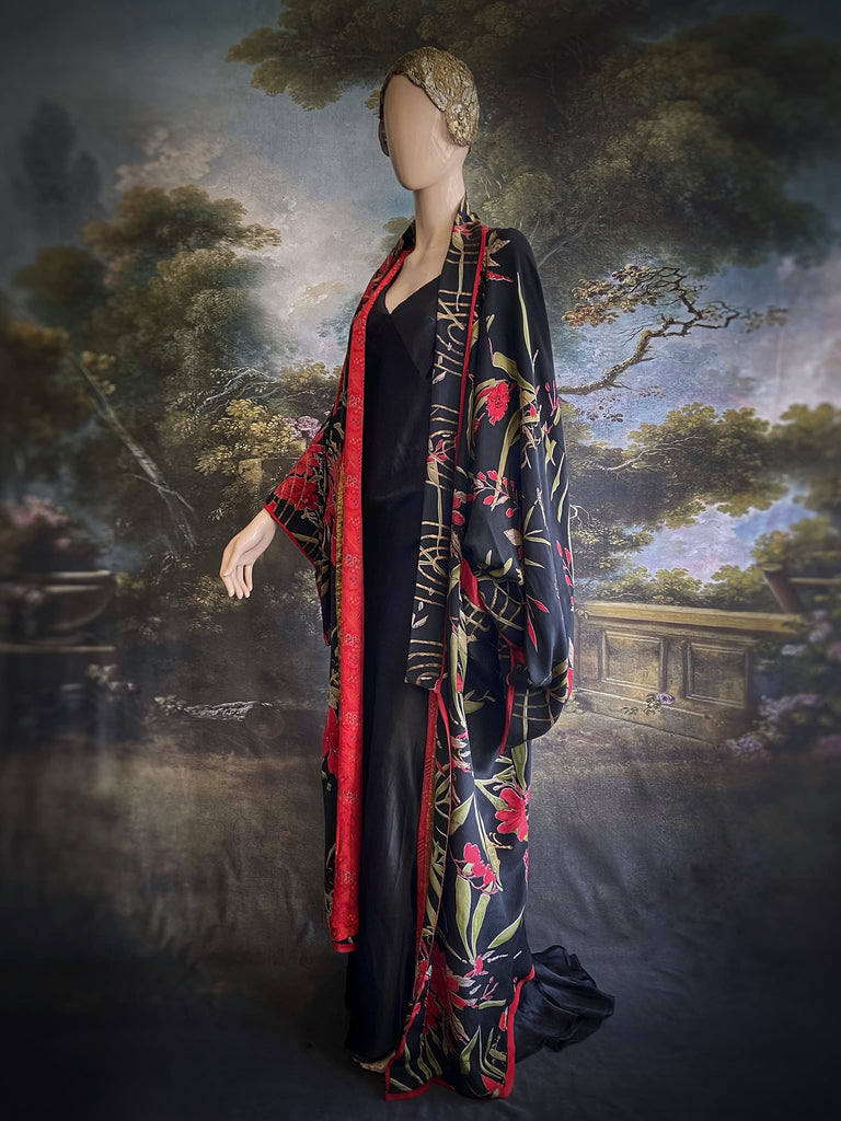Full length 1920s inspired kimono robe with large patch pockets. Newly created from a scarlet and black 1930s style splashy floral vintage silk crepe. Fully lined in silk with French seams throughout. Bohemian styles sustainably created from antique and vintage textiles by the Pavilion Parade studio.