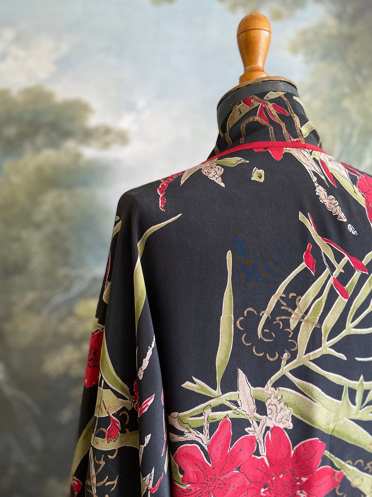 Full length 1920s inspired kimono robe with large patch pockets. Newly created from a scarlet and black 1930s style splashy floral vintage silk crepe. Fully lined in silk with French seams throughout. Bohemian styles sustainably created from antique and vintage textiles by the Pavilion Parade studio.